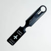 A black durable PVC luggage tag with a clip, featuring the text HAPPY FLIGHT.
