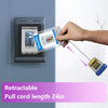 A hand is pulling a retractable badge reel with a glitter acrylic design from a dark gray electronic device.