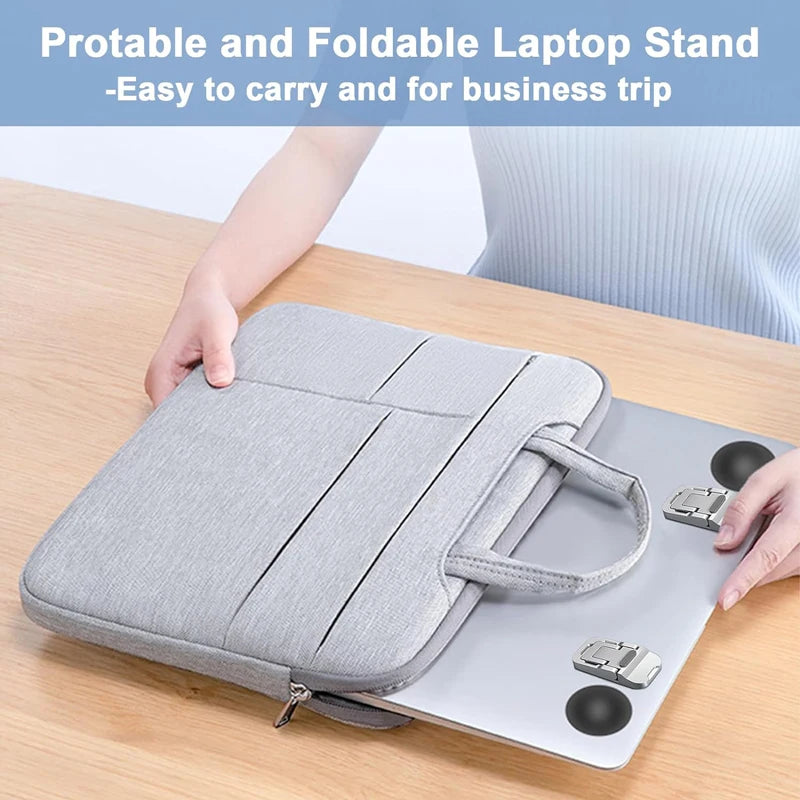 A portable and foldable laptop stand in gray fabric and metal, shown on a wooden table.