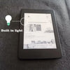 A black Kindle e-reader displaying a screen, with an inset showing a light bulb icon.