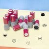 A collection of red and gray cat pattern stamps arranged on a light yellow surface.