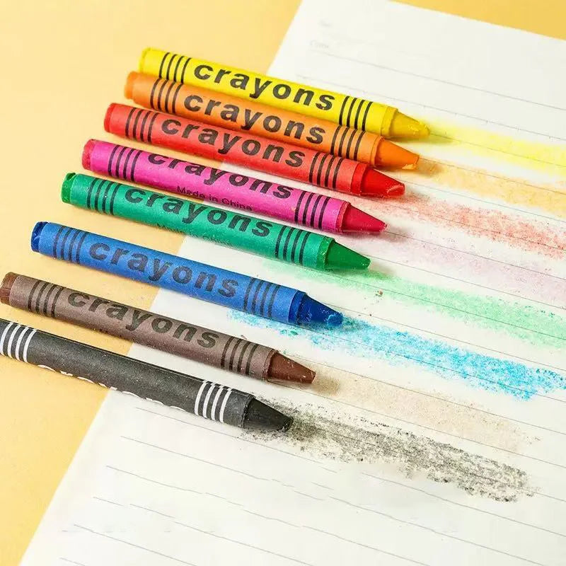 A collection of colorful wax crayons arranged diagonally on a white sheet of paper.