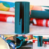 A teal portable mini paper cutting machine shown in various angles and with paper sheets.