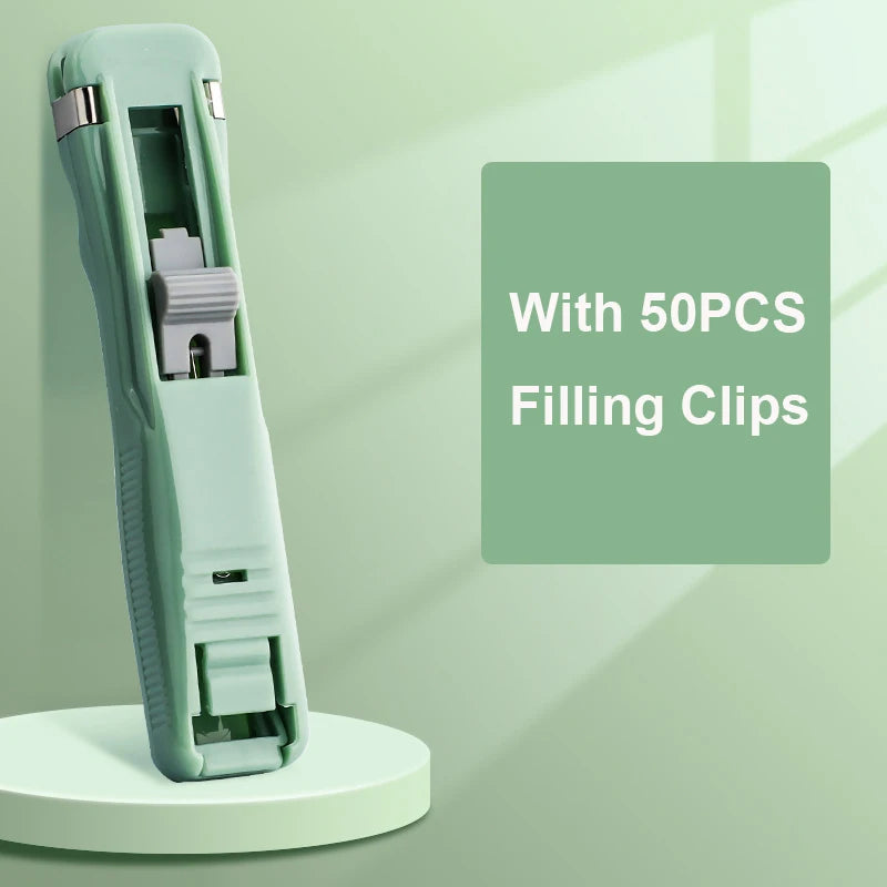 A light green handheld binder clip pusher tool with a green body and stainless steel refill clips, shown against a pale green