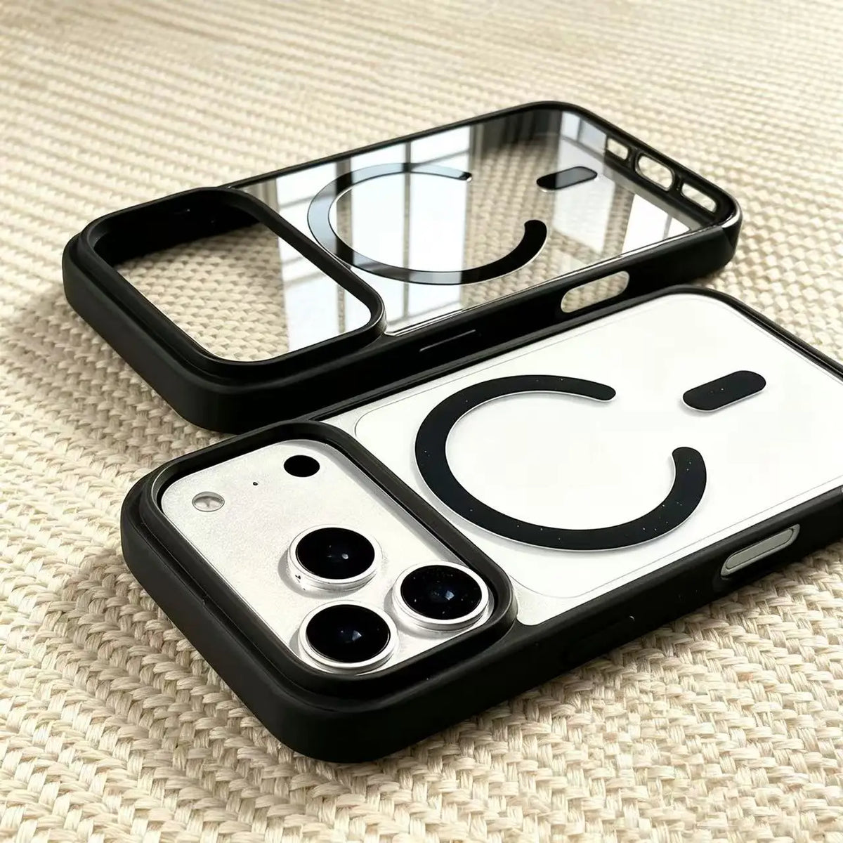 A transparent acrylic phone case with a black MagSafe compatible phone and a matching clear silicone grip.