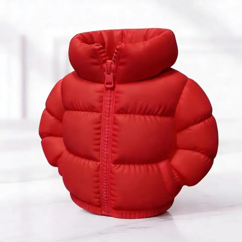 A bright red puffer jacket pen holder with a zipper and quilted texture.