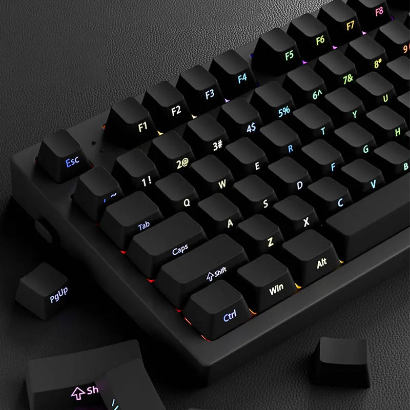 A close-up view of black PBT double-shot cherry profile keycaps on a mechanical keyboard.