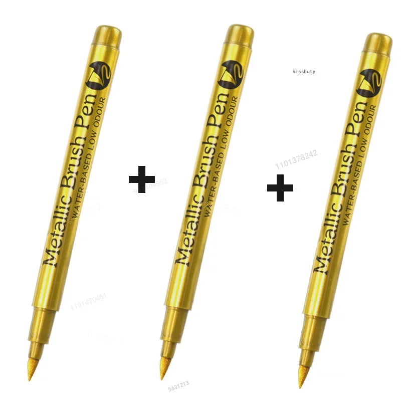 Three metallic brush pen markers shown in gold color with black tips and packaging.