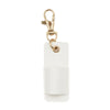 A white leather pen holder keychain with a brass clasp.