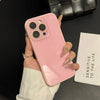 A hand holds a pink iPhone with a clear case and gold-accented nails against a dark background.