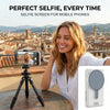 A woman is using a magnetic selfie screen for her mobile phone camera in an outdoor setting.
