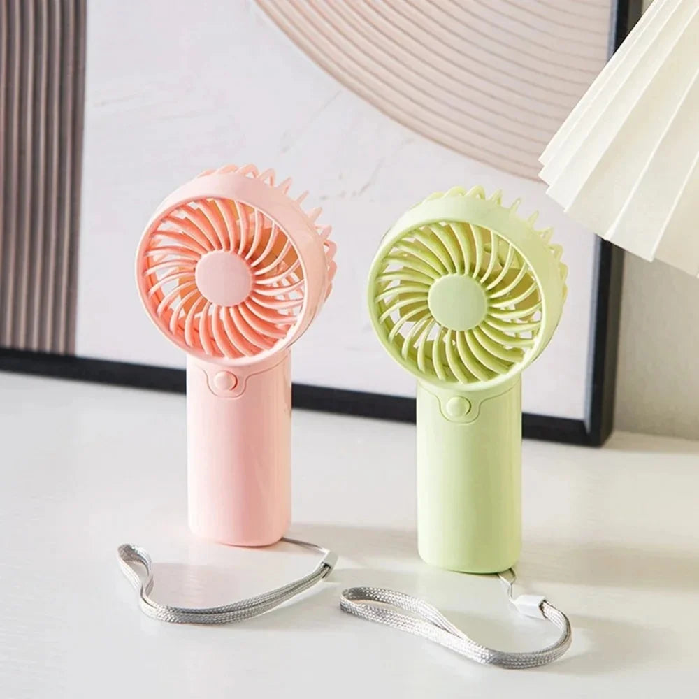 Two portable rechargeable mini handheld fans in pink and light green colors with attached wires