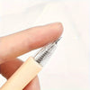 A hand holds a silver retractable craft knife pen set, showing the tip and body of the tool.