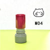 A red and gray teacher stamp with a cat face design is shown on a yellow surface.