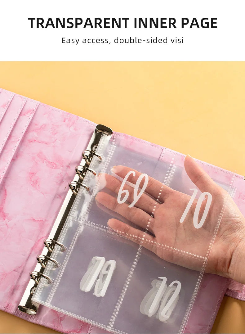 A hand holds a transparent inner page of an A5 marble budget binder showing cash envelopes.