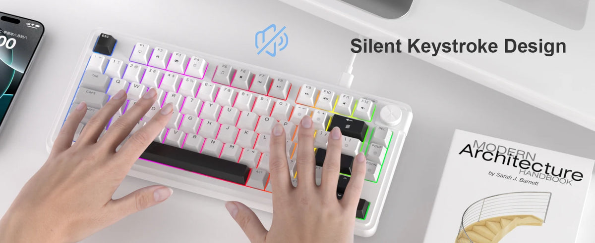 Una mano está tecleando en un teclado de membrana compacto blanco con diseño de tecla silenciosa y un pomo giratorio.