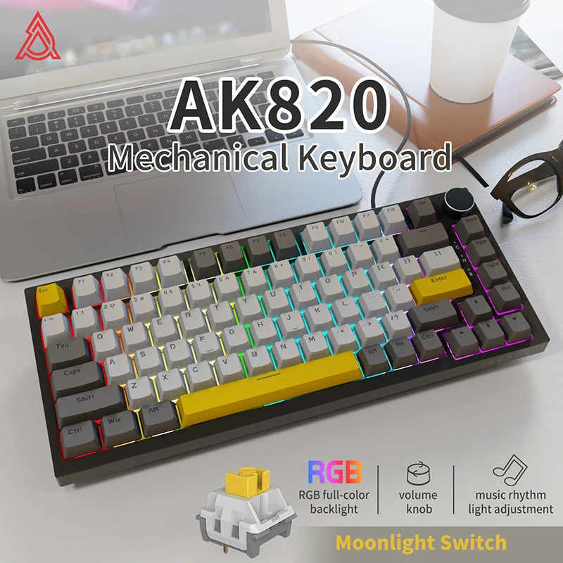 A black mechanical keyboard with RGB backlight and a yellow keycap is shown next to a laptop.
