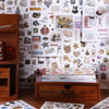 Aesthetic scrapbooking sticker book featuring nature and animal patterns displayed next to a wooden storage box.