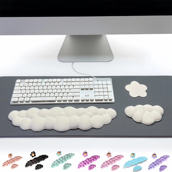 A set of three white cloud-shaped keyboard wrist rests and a gray keyboard shown on a dark surface.