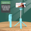 A blue mobile phone holder tripod with an attached phone and a selfie stick setup on a wooden table.