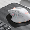 A wireless MMO gaming mouse with programmable buttons and RGB lighting resting on a gray mousepad.