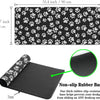 Black pet paw print desk mat with a non-slip rubber base designed to prevent sliding.