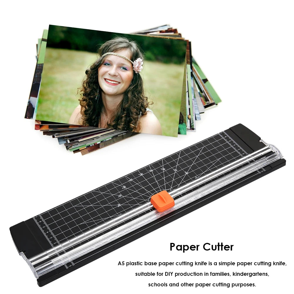 An A5 plastic base paper cutting knife with a clear blade and orange handle is shown next to a stack of paper.