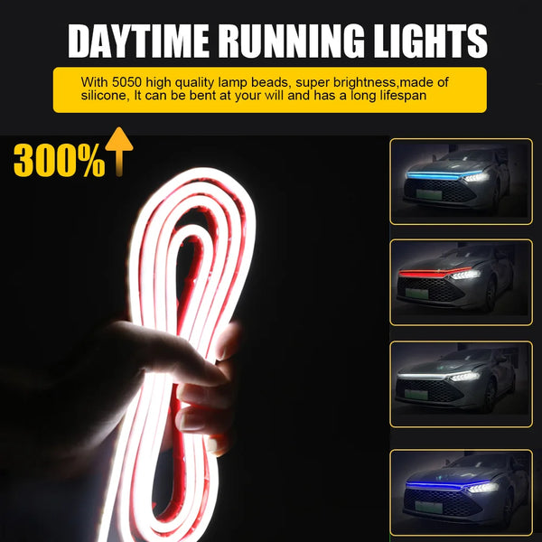 A hand holds a flexible LED light strip illuminating the front grille of a car.