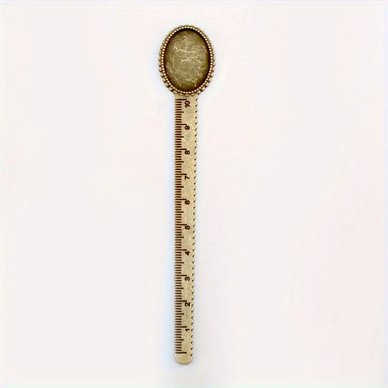 Vintage brass straight ruler with a round, textured tip and minimalist design.