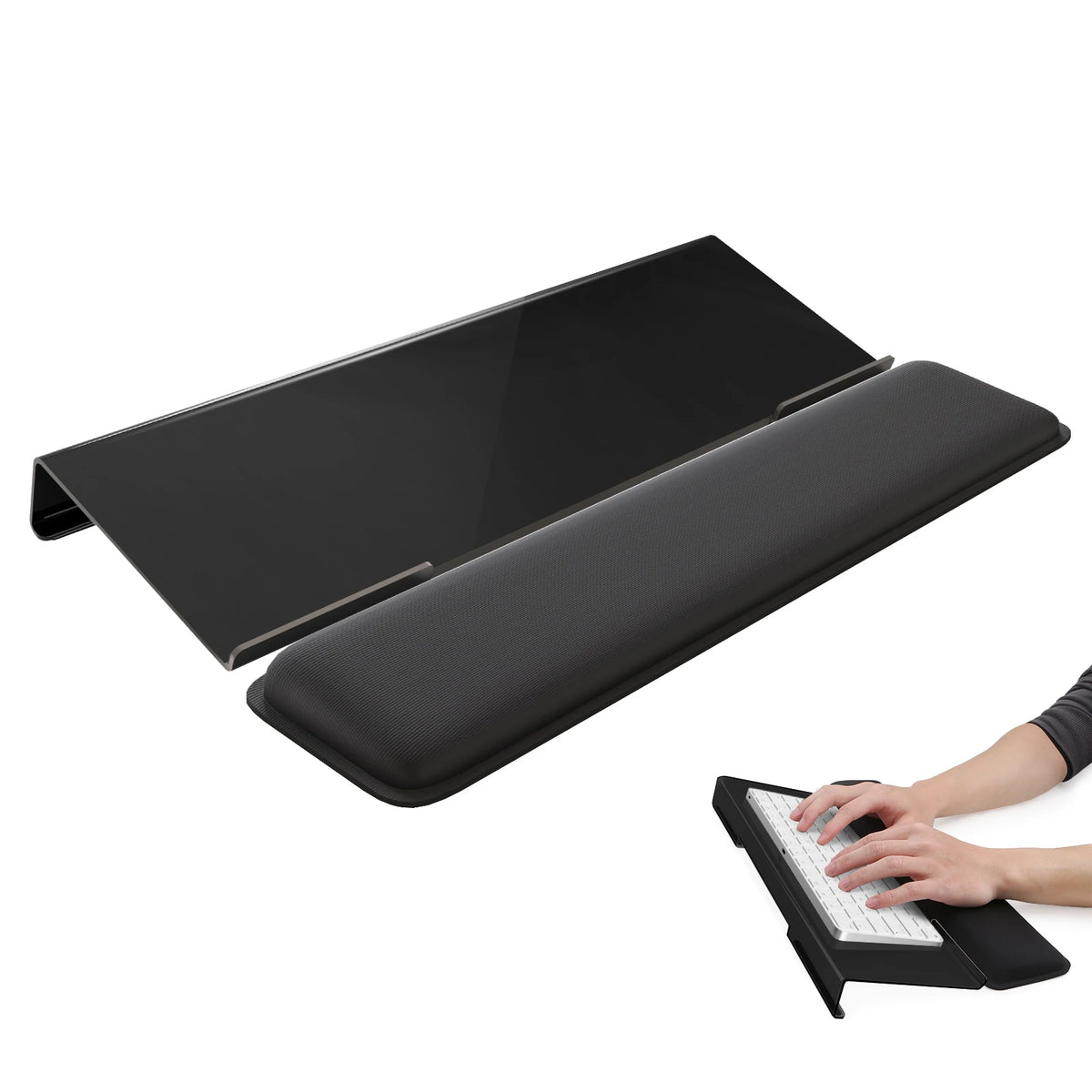 A black ergonomic acrylic keyboard wrist rest stand shown next to a hand typing on a laptop.