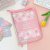 A pink A5 envelope budget binder set for cash organization with a clear plastic sleeve and floral pattern.