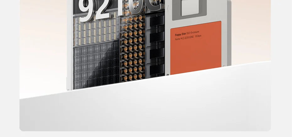 A close-up view of an M.2 NVMe SSD enclosure with a black and silver design and an orange label.