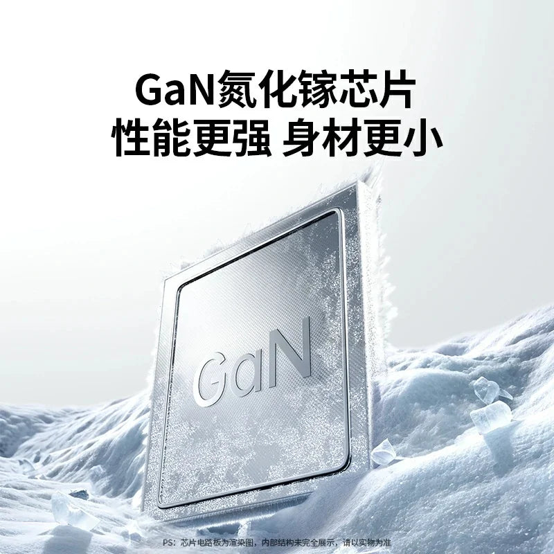 A silver GaN fast charger is shown resting on a snowy surface.