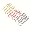 A collection of mixed color heart-shaped metal pen clips in gold and rose gold tones.