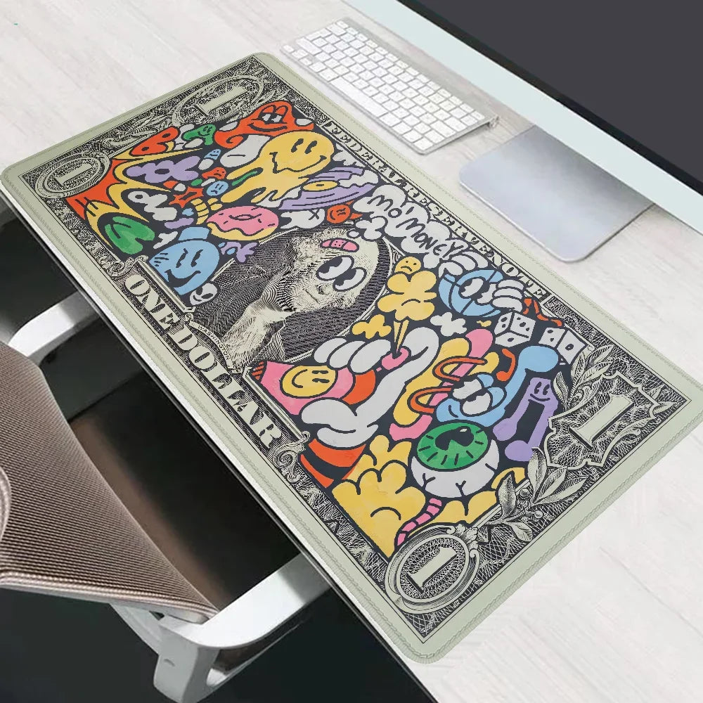 A black and colorful extended gaming desk mat featuring cartoon characters and dollar signs placed on a white wooden desk.