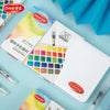 A box of a 12-in-1 watercolor paint set featuring various colors and a water brush pen is shown on a light blue surface.