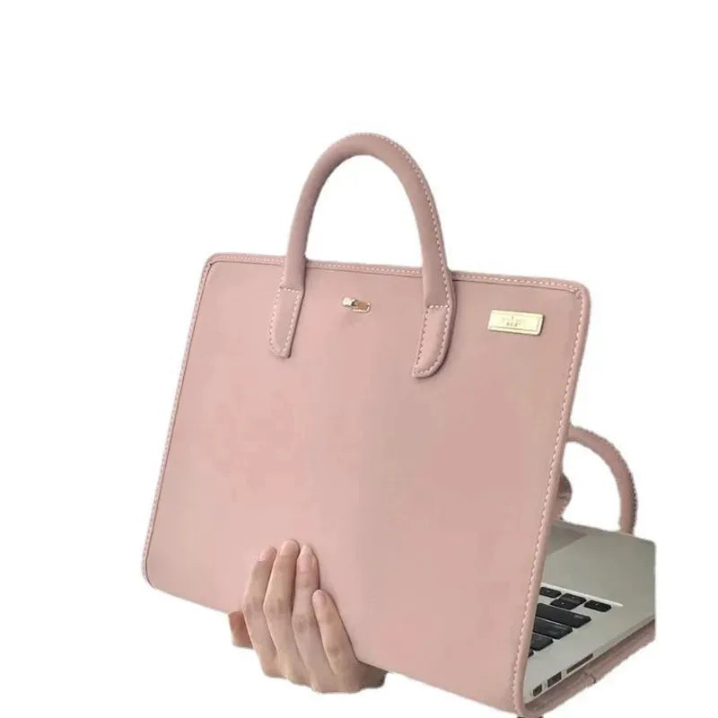 A pink laptop sleeve with a handle is shown resting on a silver laptop.