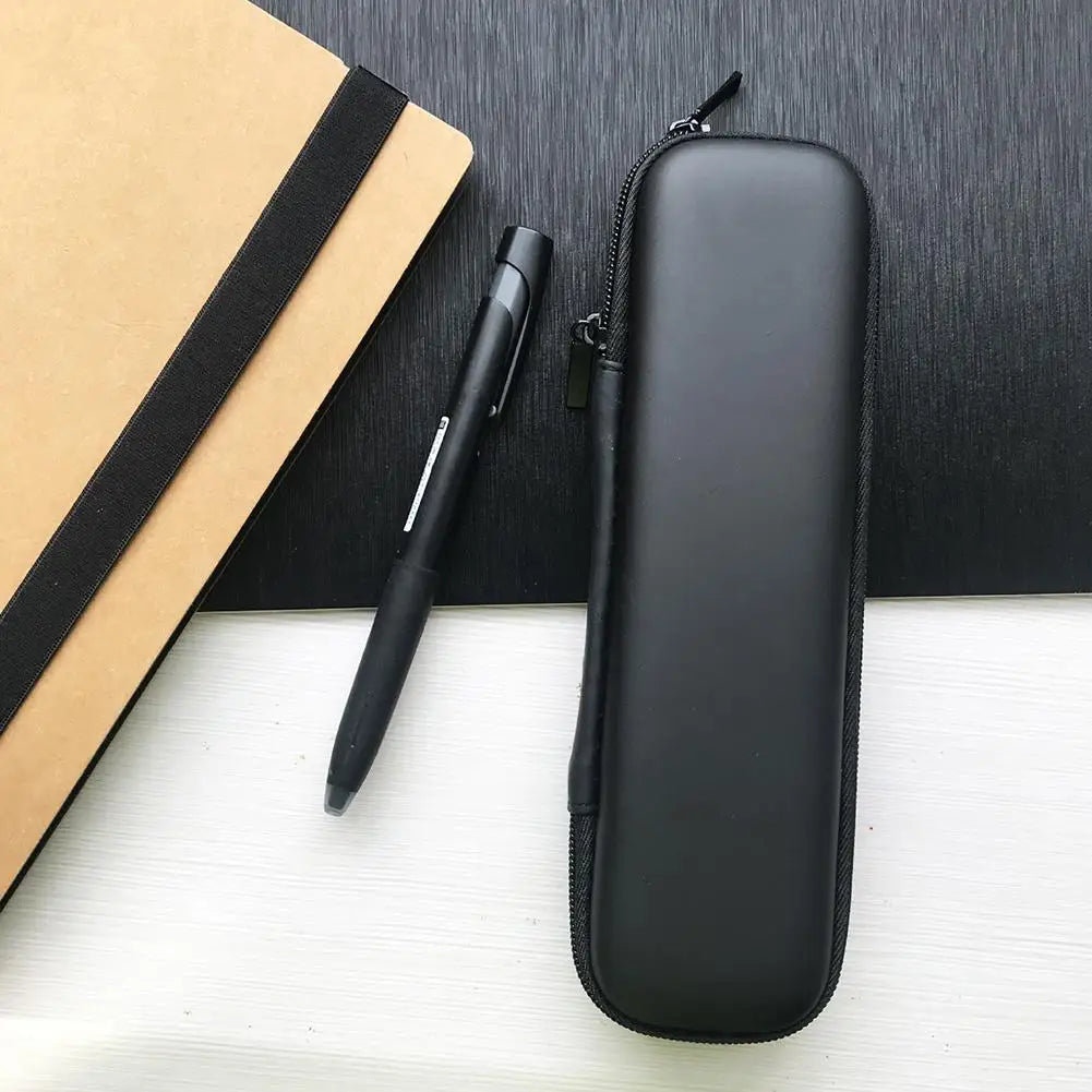 A black compact EVA hard shell pencil case with a zipper and mesh pockets resting on a white surface next to a black pen.