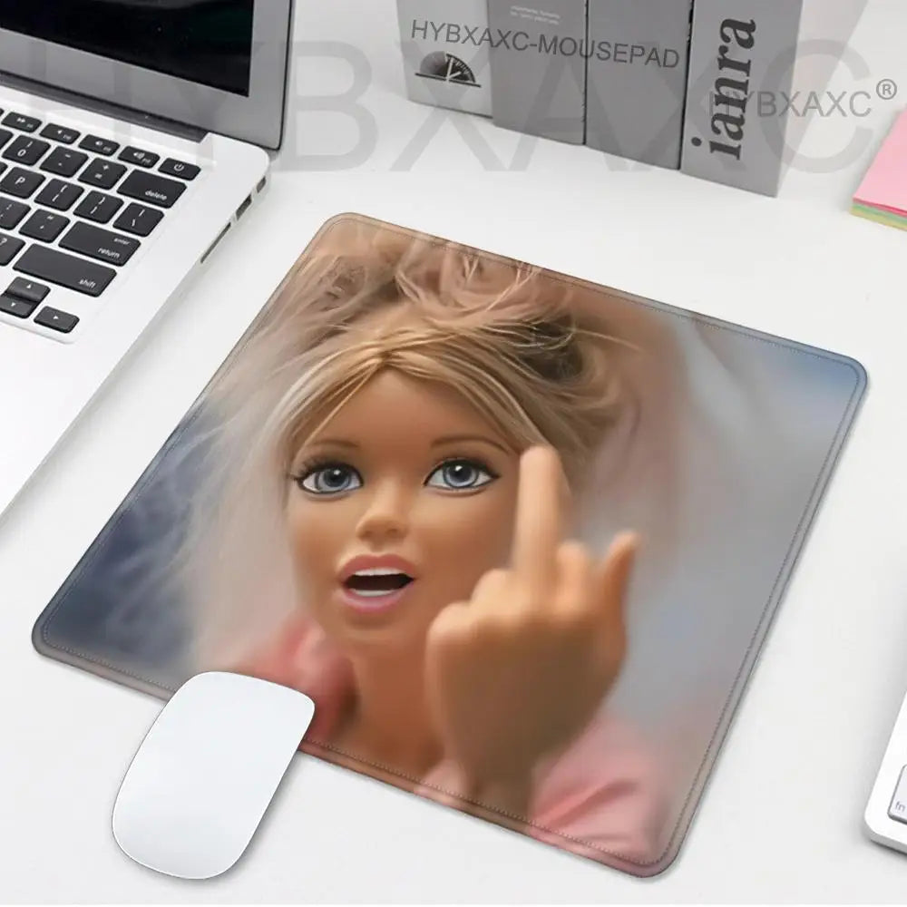 A mouse pad featuring a close-up image of a playful doll face with light hair and blue eyes.