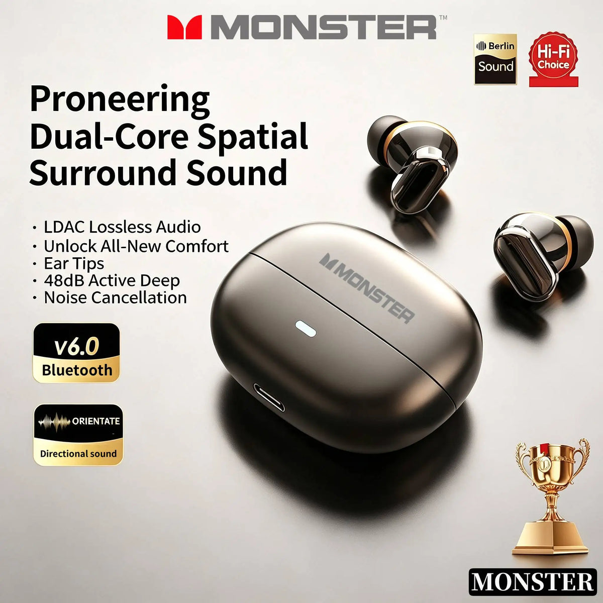 A black Monster dual-core spatial surround sound headphone and ear tips displayed on a dark surface.