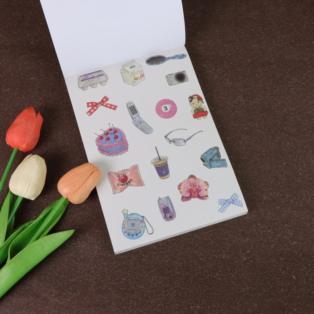 A white sticker book page filled with various fruit-themed icons and craft items for journaling and decorating.