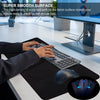 A hand rests on a black desk mat mouse pad with a computer mouse nearby.