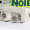 A beige pencil case with a transparent flip pocket featuring bear illustrations and a calendar.