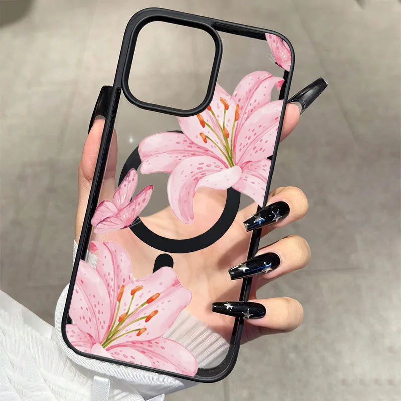 A hand holds a pink lily floral transparent iPhone case with a black shockproof bumper.