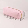 A pink ribbed pencil case with a gold zipper shown lying flat.