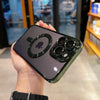 A hand holds a smartphone in a clear magnetic case with a green finish, displaying the Apple logo.