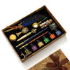 A luxury fountain pen set with a wax seal kit displayed in a wooden box.