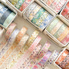 A collection of five rolls of floral washi tape in various pastel colors and patterns for journaling and crafts.