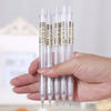 A hand holds a set of clear plastic mechanical pencils with different tip sizes.