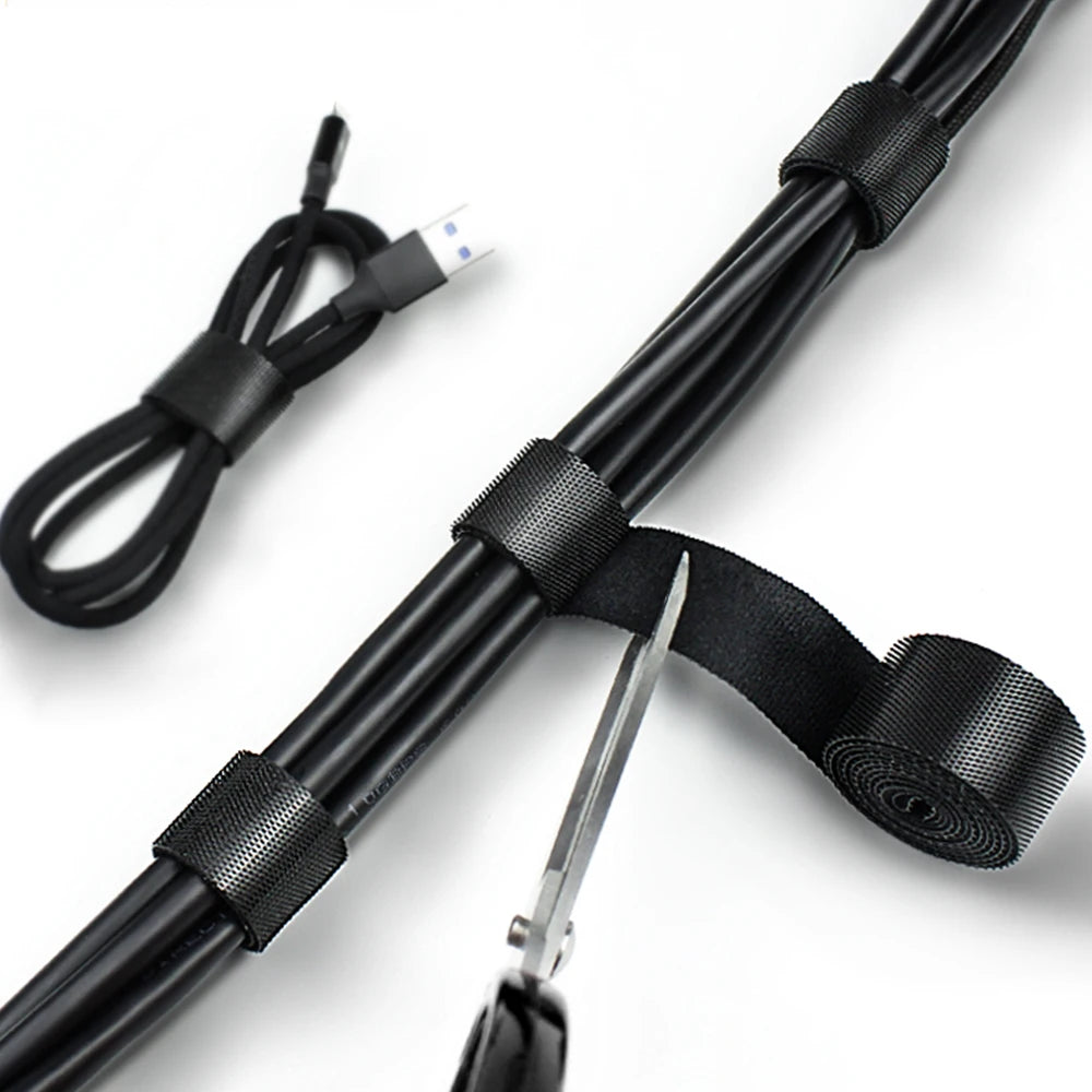 Black cable organizer kit featuring a flexible cable and Velcro straps for managing desk electronics